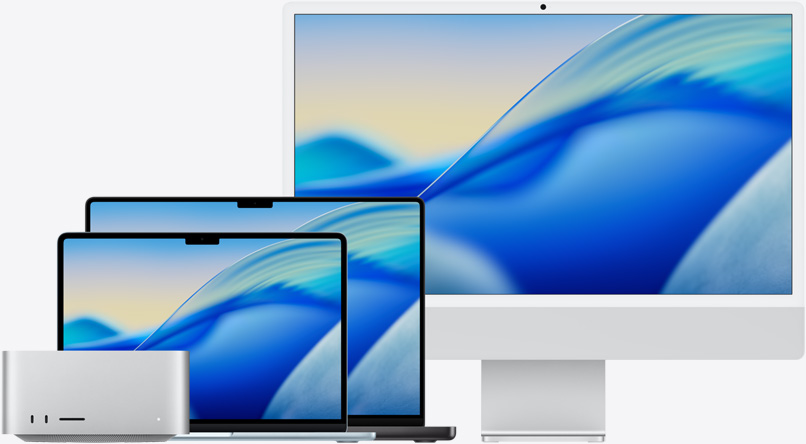 De gauche à droite, le fond d’écran macOS Tahoe sur plusieurs modèles Mac: Mac Studio, MacBook Air 13 pouces bleu ciel, MacBook Pro 14 pouces noir sidéral et iMac 24 pouces argent